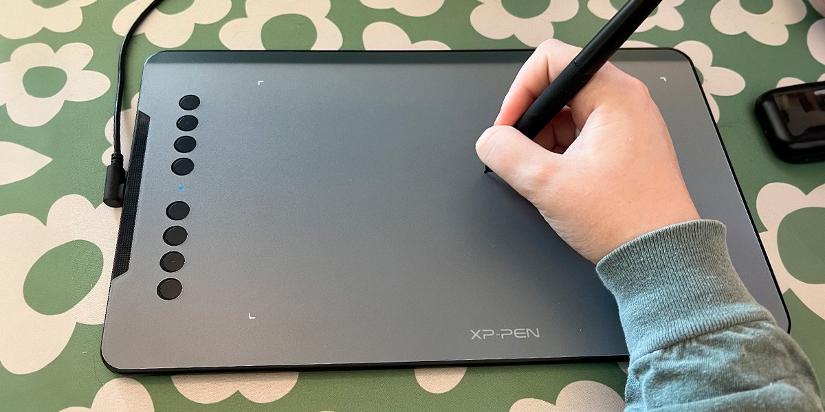 Person using  XP-Pen Deco 01 V2 on green and white background
