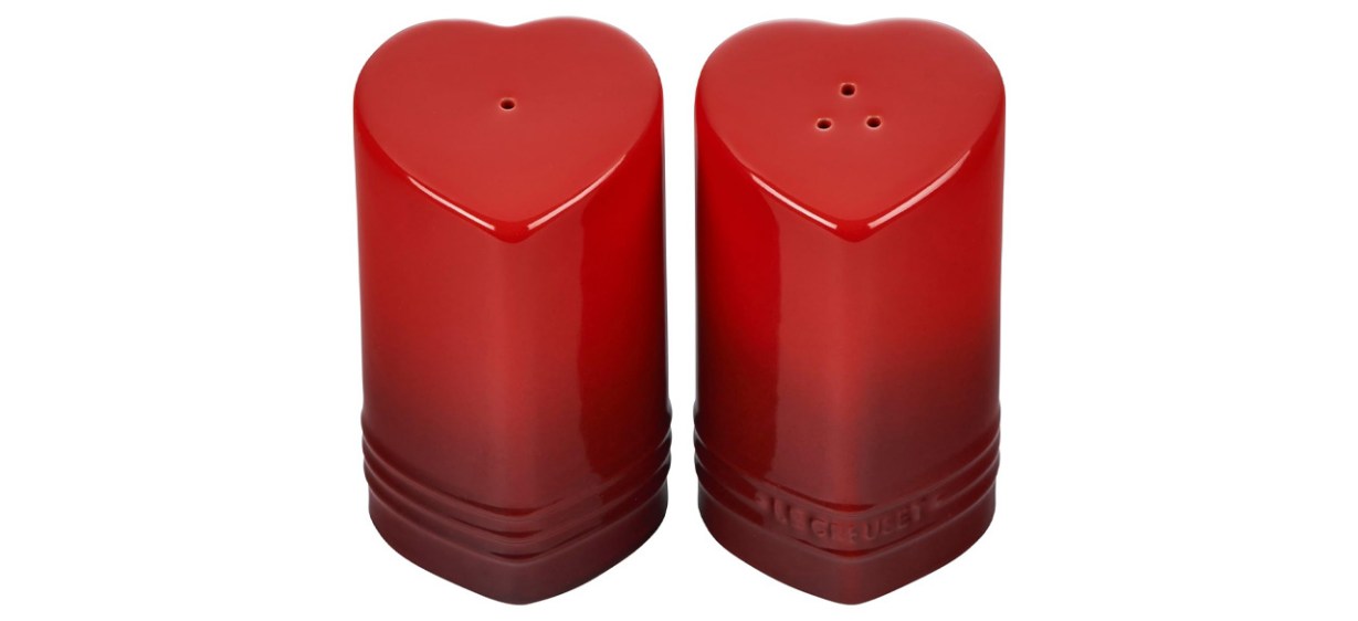 Red Le Creuset Stoneware Heart Shaped Salt &amp; Pepper Shakers on white background