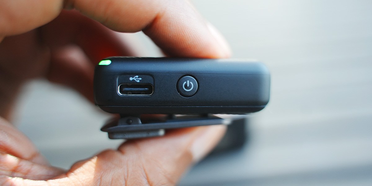 Two fingers holding DJI Mic Two fingers holding DJI Mic