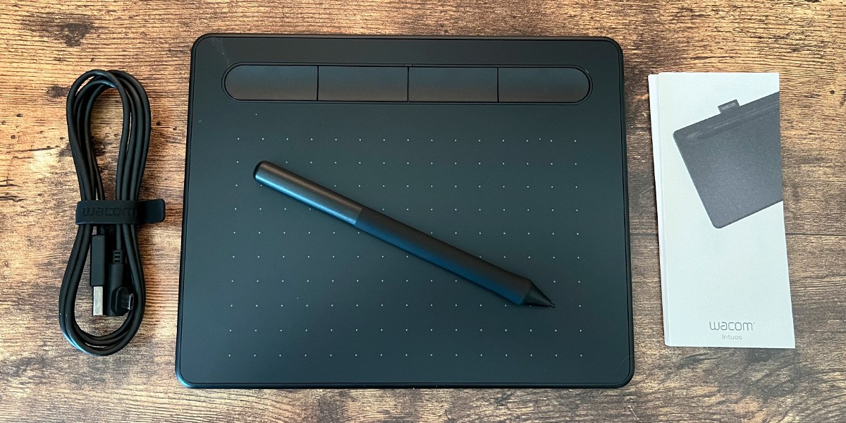 Wacom Intuos Small Graphics Drawing Tablet with accessories on wood background
