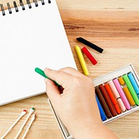 a hand about to color using oil pastel