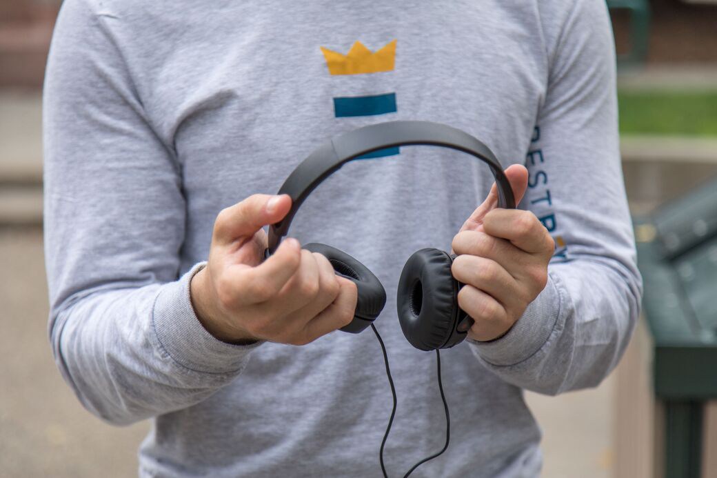 Person holding headphone set
