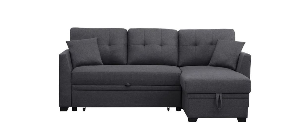 a dark gray three-seated, L-shaped sofa