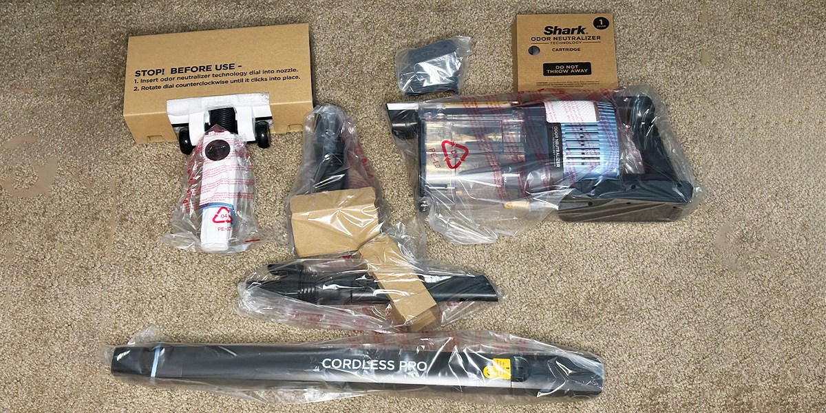Various Shark Cordless Pro attachments displayed on carpet