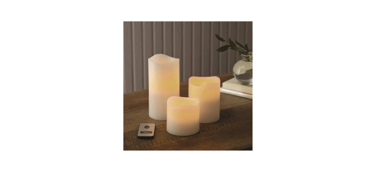 Better Homes and Gardens Flameless LED Pillar Candles sitting on a table with a remote