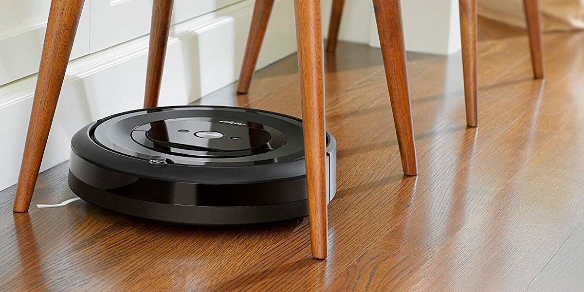 Robot vacuum navigating on hard floor beneath chair legs