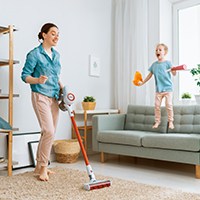 a woman using a vacuum cleaner